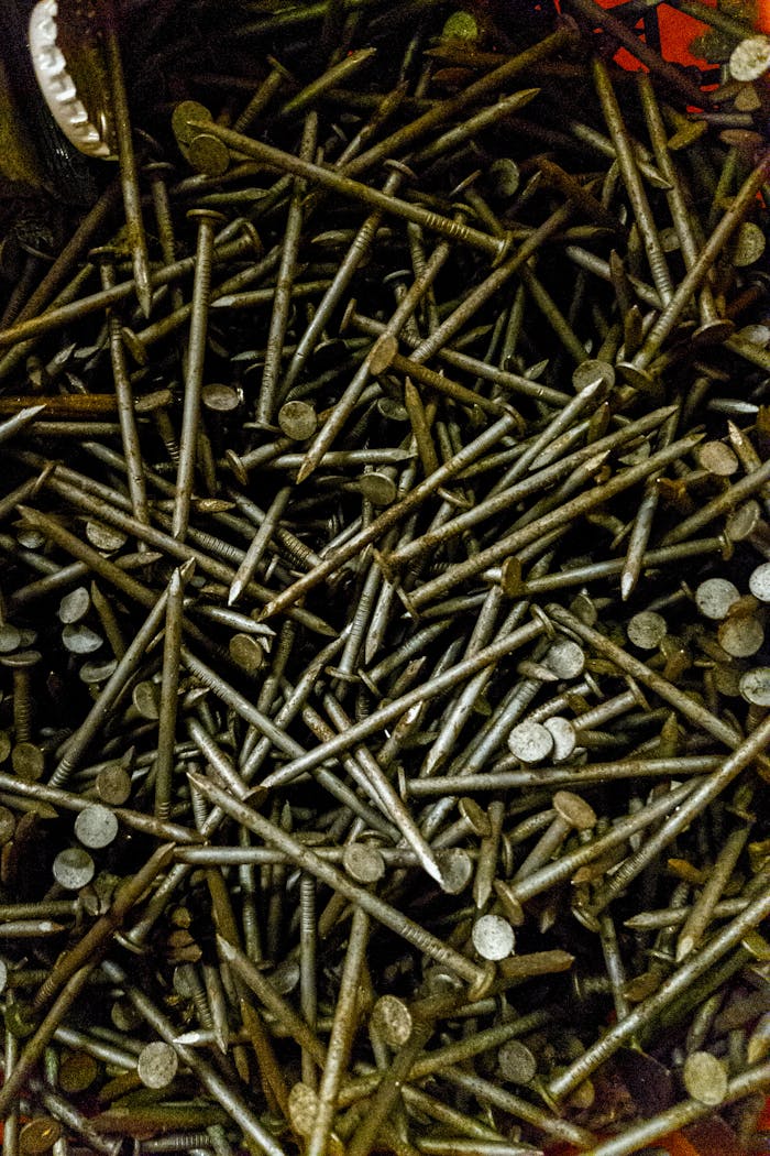 Close-up of scattered rusty nails showcasing industrial texture and aesthetic.